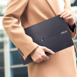 Person in suit carrying ASUS ZenScreen 16 Inch Portable Monitor (MB16AHV)